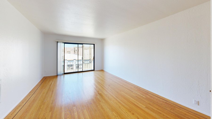 A room with wooden floors and a window.